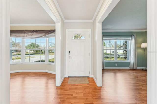 entrance foyer featuring crown molding and light hardwood / wood-style flooring