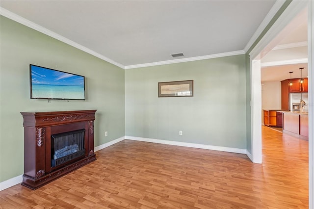 unfurnished living room with light hardwood / wood-style flooring and ornamental molding