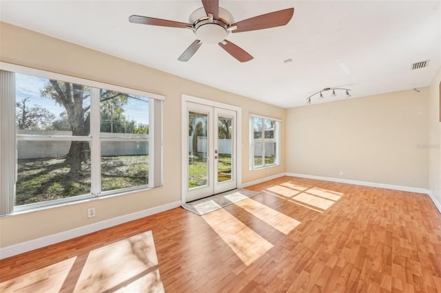 interior space with ceiling fan and french doors