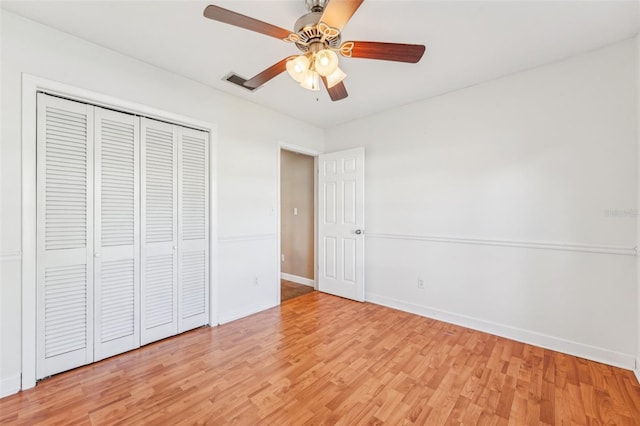 unfurnished bedroom with a closet, ceiling fan, and light wood-type flooring