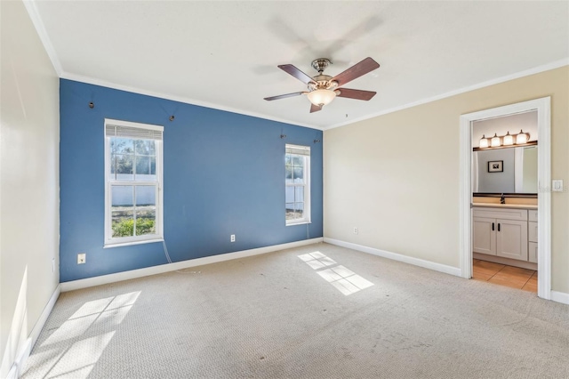 unfurnished bedroom with crown molding, ceiling fan, ensuite bathroom, and light colored carpet