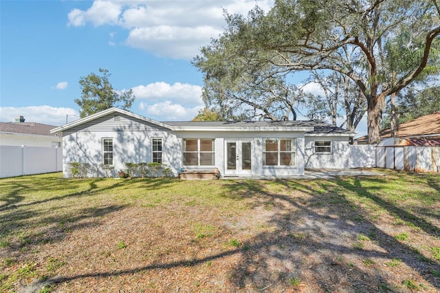 back of house featuring french doors and a yard