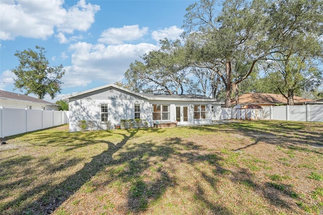 rear view of house with a lawn