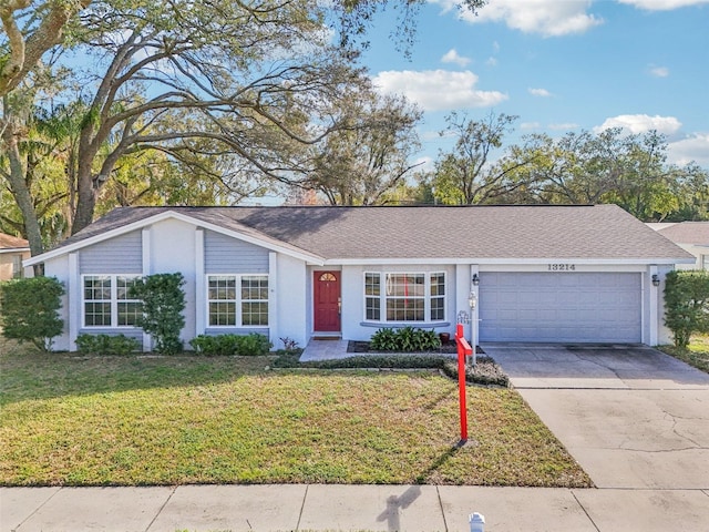 single story home featuring a garage and a front yard