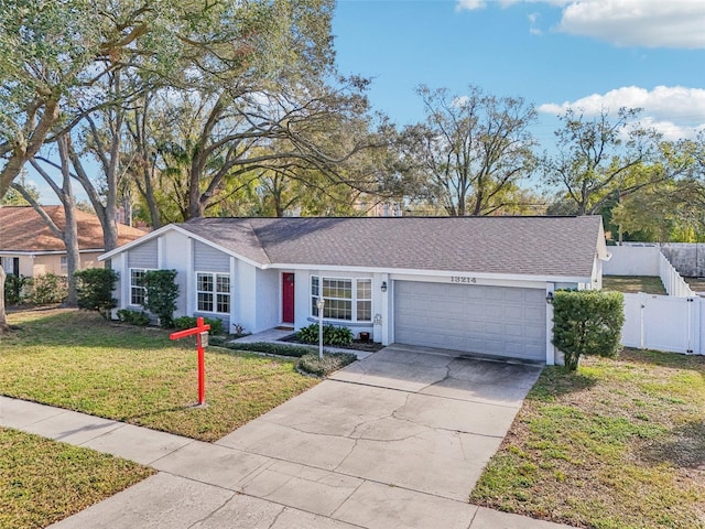 single story home featuring a garage and a front lawn