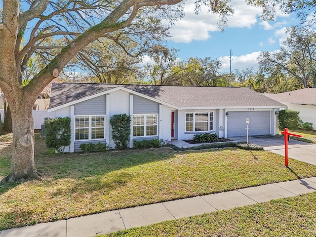 single story home featuring a garage and a front yard