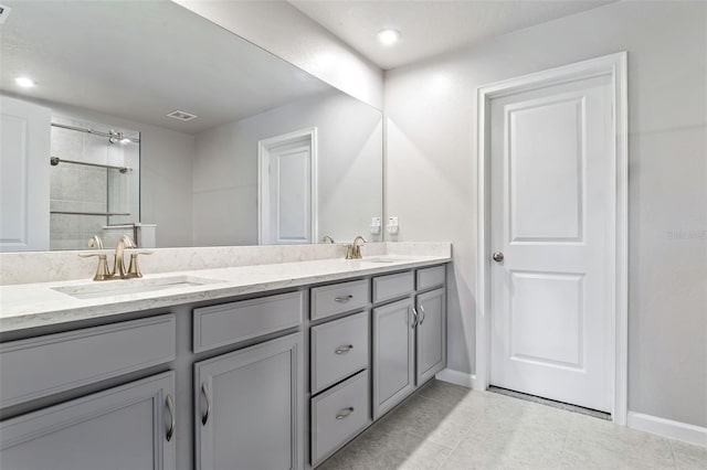 bathroom featuring tiled shower and vanity