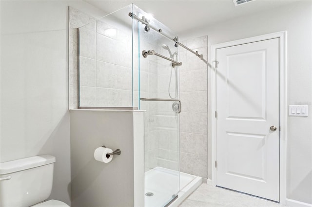 bathroom featuring toilet and an enclosed shower