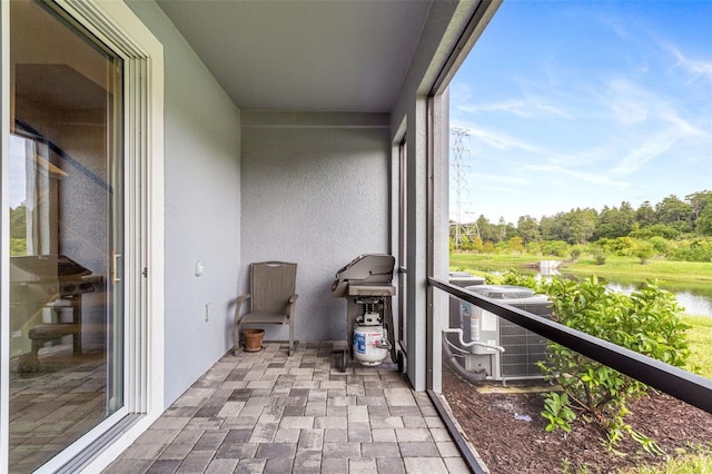 balcony with cooling unit and a water view