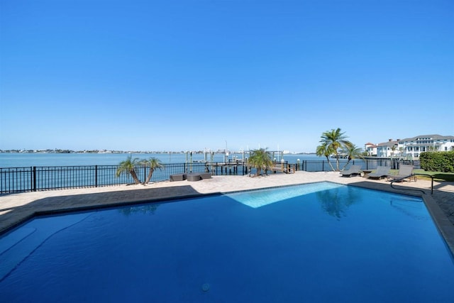 view of swimming pool featuring a water view