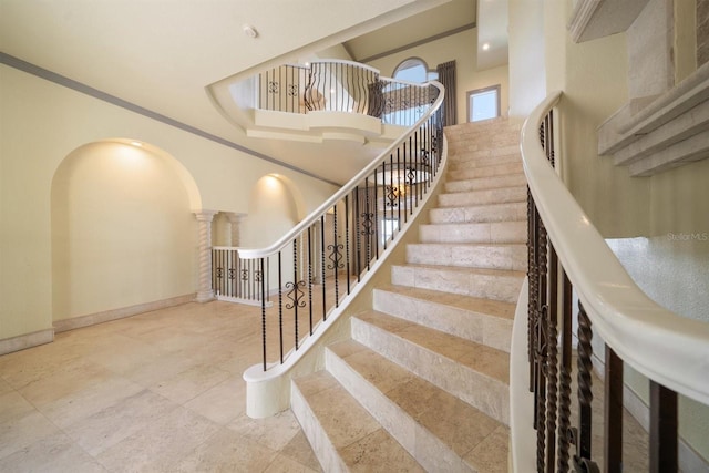 staircase with a high ceiling