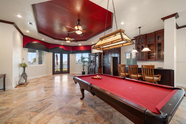 playroom featuring french doors, billiards, ornamental molding, and a tray ceiling