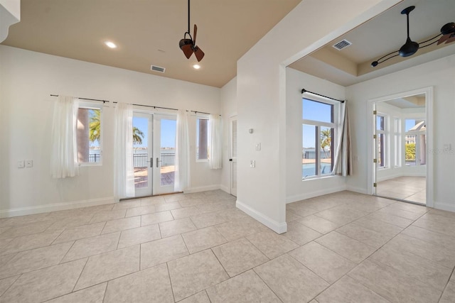 tiled entrance foyer featuring french doors and ceiling fan