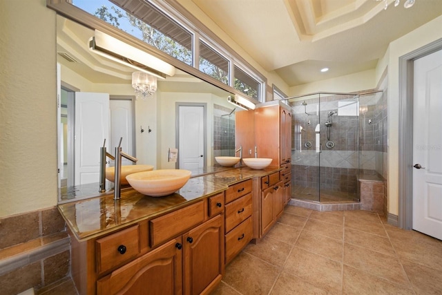 bathroom featuring walk in shower, vanity, tile patterned flooring, and a notable chandelier