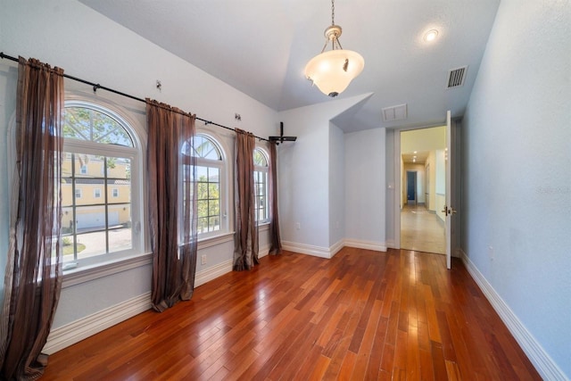 unfurnished room with dark wood-type flooring