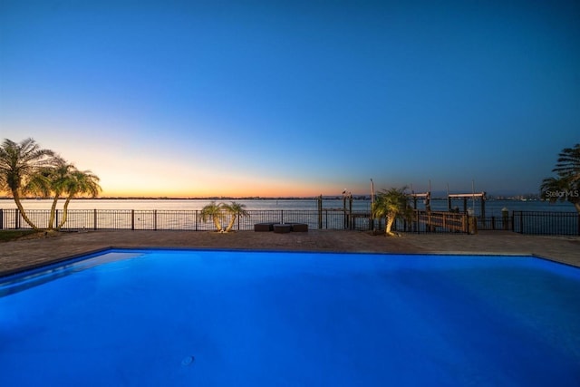 pool at dusk with a water view