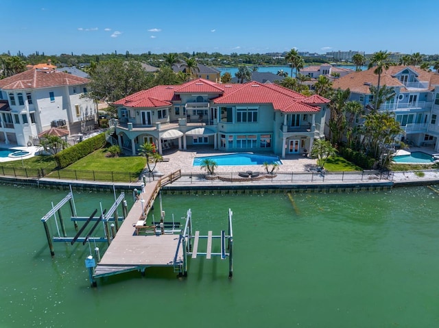 dock area featuring a yard, a fenced backyard, boat lift, a patio area, and a balcony