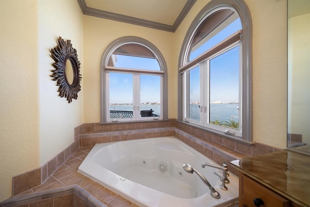 bathroom featuring a jetted tub, a water view, and ornamental molding