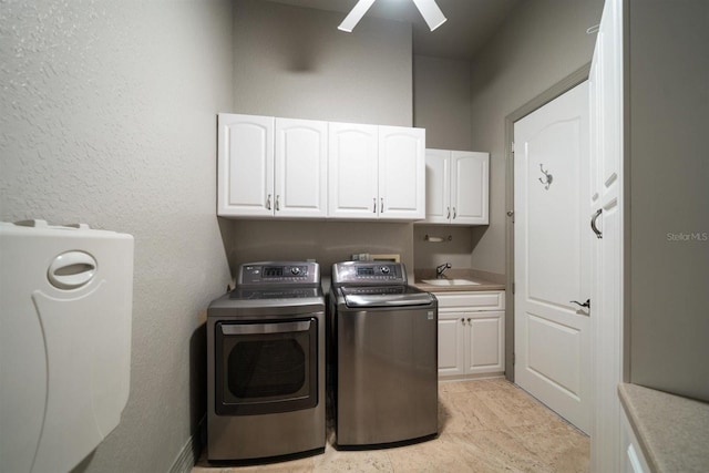 laundry area with washing machine and dryer, a ceiling fan, a sink, and cabinet space