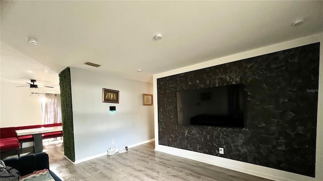 living room with hardwood / wood-style floors and ceiling fan