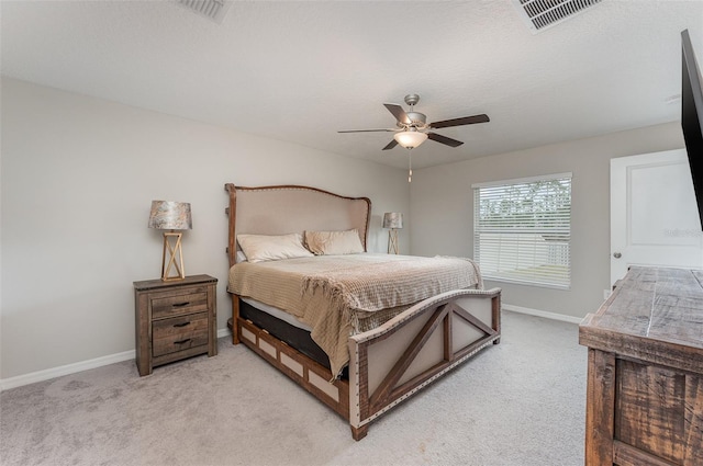 carpeted bedroom with a textured ceiling and ceiling fan