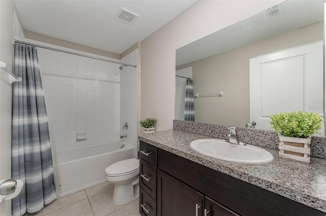 full bathroom featuring shower / bath combo, tile patterned flooring, vanity, a textured ceiling, and toilet