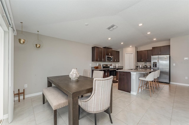 dining space with light tile patterned floors, recessed lighting, visible vents, baseboards, and vaulted ceiling