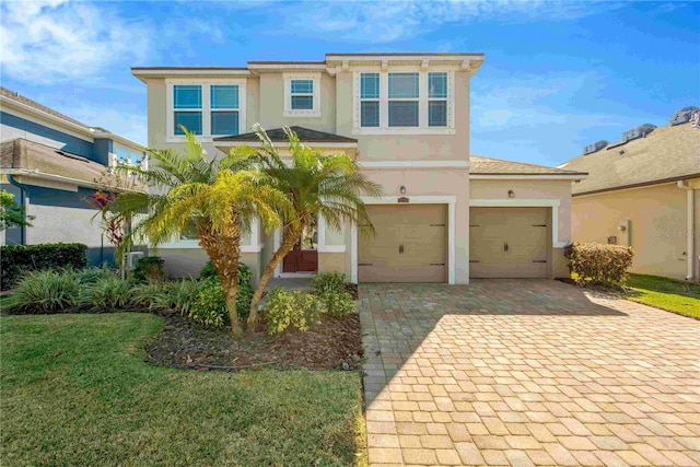 view of front of property with a garage and a front lawn