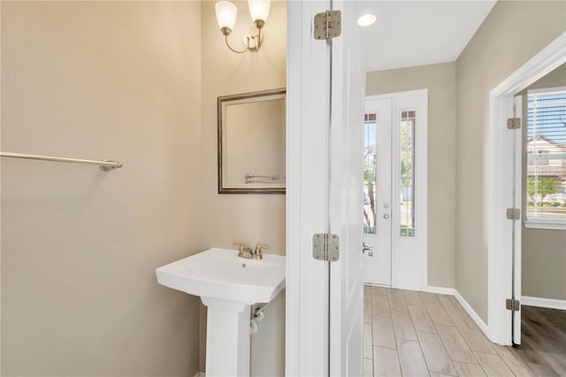 bathroom with sink, hardwood / wood-style flooring, and plenty of natural light