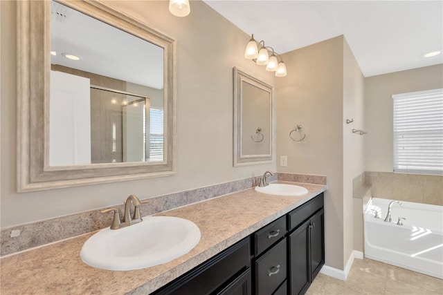 bathroom featuring tile patterned flooring, vanity, and separate shower and tub