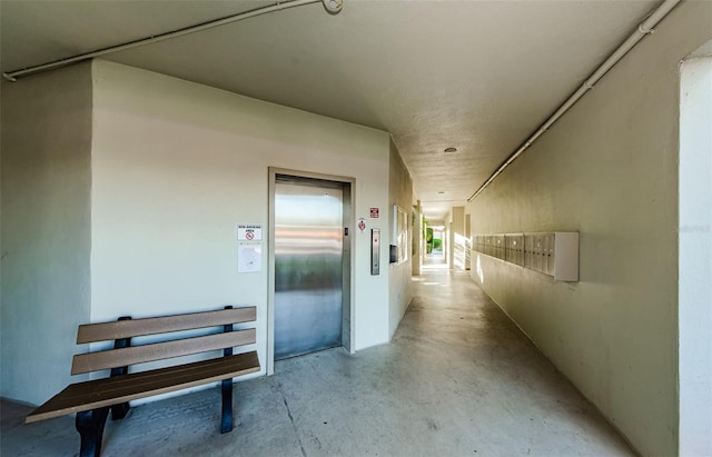 hallway with mail boxes and elevator