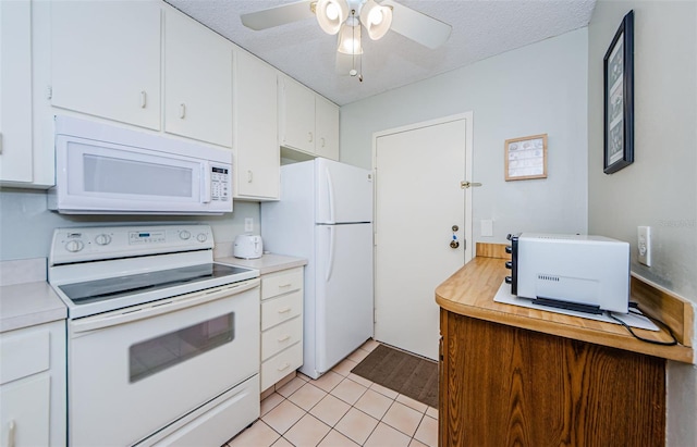 kitchen featuring white appliances, a textured ceiling, light tile patterned floors, ceiling fan, and white cabinets