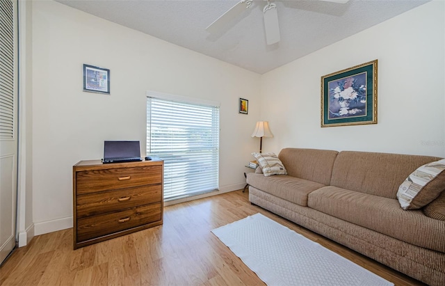 living room with light hardwood / wood-style floors and ceiling fan