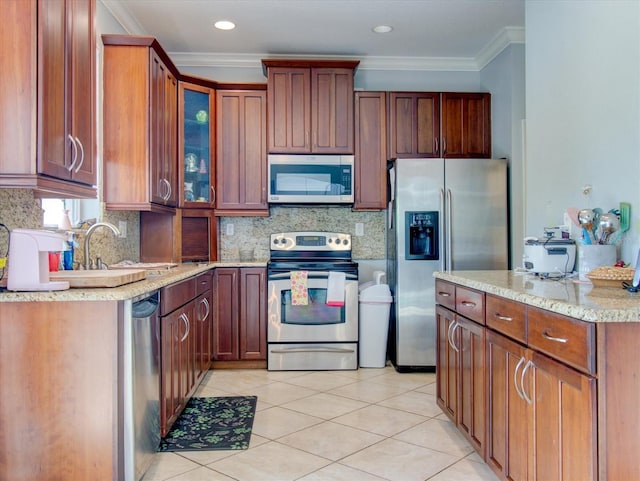 kitchen featuring ornamental molding, appliances with stainless steel finishes, light tile patterned flooring, and decorative backsplash