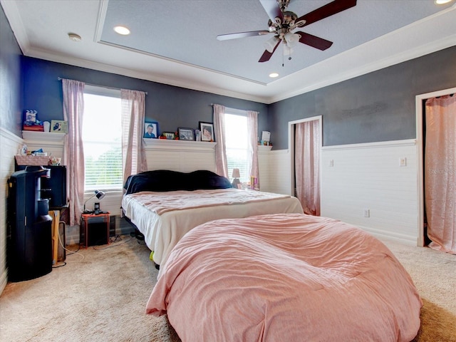 carpeted bedroom featuring ceiling fan and multiple windows