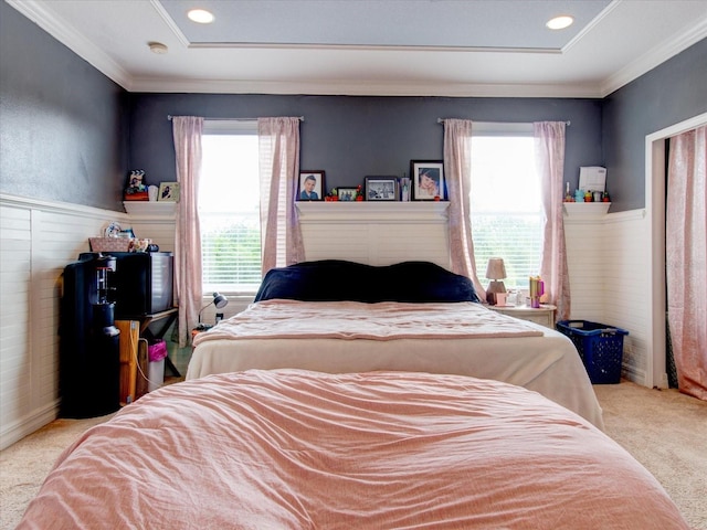 carpeted bedroom featuring crown molding and multiple windows