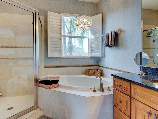 bathroom featuring vanity, plus walk in shower, and an inviting chandelier