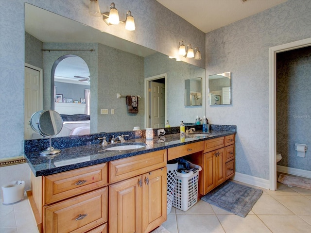 bathroom featuring tile patterned flooring, vanity, toilet, and ceiling fan