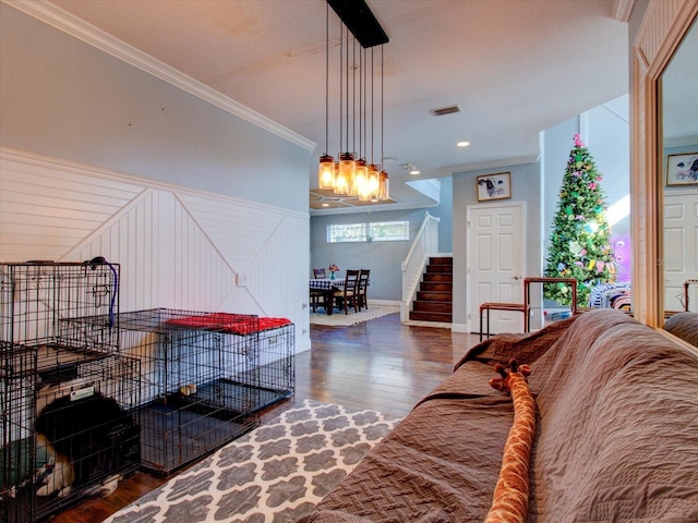 living room featuring ornamental molding and dark hardwood / wood-style flooring