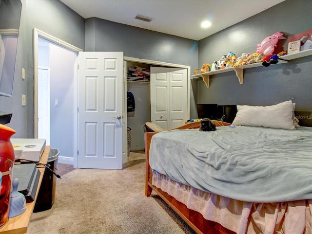 bedroom featuring light colored carpet and a closet