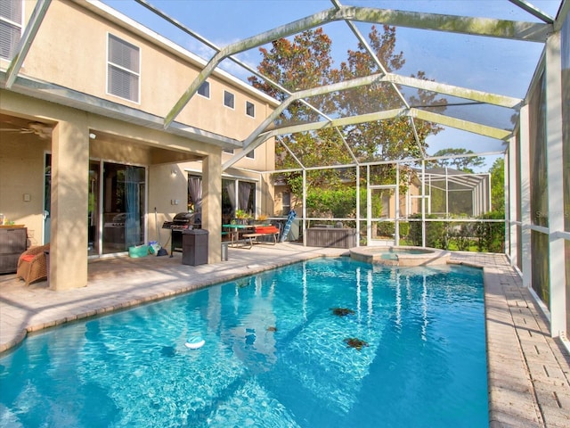 view of pool featuring an in ground hot tub, glass enclosure, and a patio