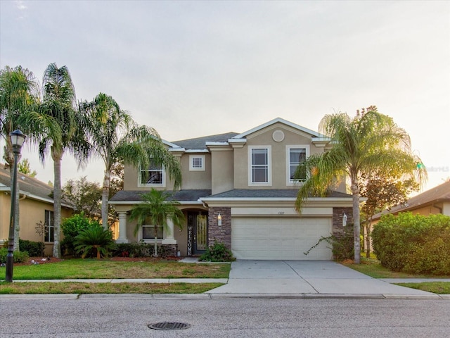 view of front facade featuring a garage and a front lawn