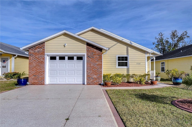 ranch-style house featuring a garage and a front yard