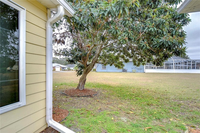 view of yard featuring a lanai