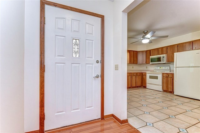 kitchen featuring ceiling fan and white appliances