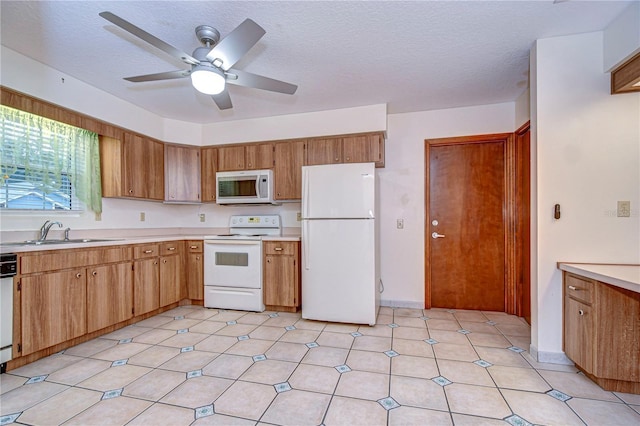 kitchen with sink, white appliances, a textured ceiling, and ceiling fan