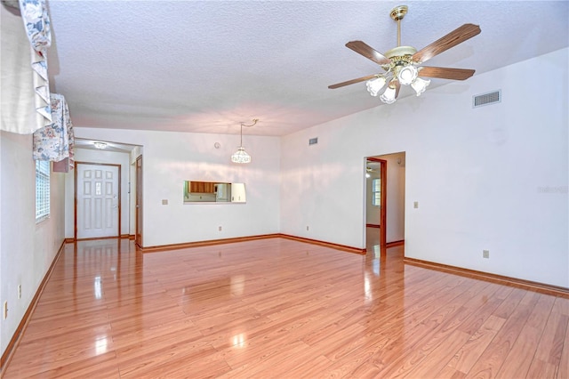 unfurnished living room with ceiling fan, light hardwood / wood-style flooring, and a textured ceiling