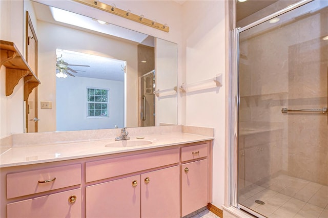 bathroom with vanity, ceiling fan, and walk in shower