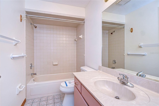 full bathroom featuring vanity, tiled shower / bath, tile patterned floors, and toilet