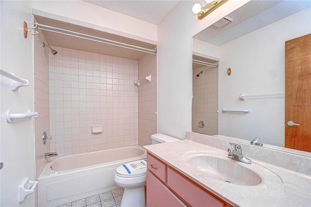 full bathroom with tile patterned floors, toilet, tiled shower / bath, a textured ceiling, and vanity